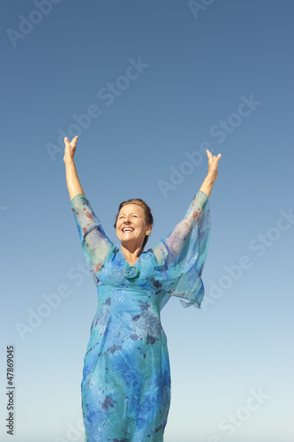 Portrait joyful mature woman isolated sky