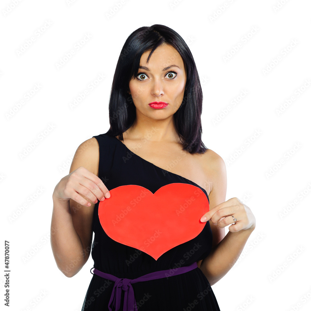 Surprised girl with red Valentine heart isolated on white Surprised girl with red Valentine heart isolated on white