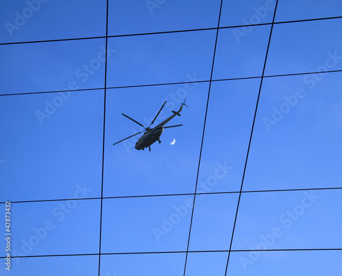 helicopter in the sky through electric wires