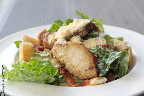 Chicken ceasar salad in a white plate