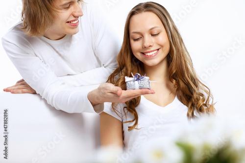 Young couple at home with present