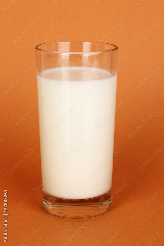 Glass of fresh new milk on brown background Glass of fresh new milk on brown background