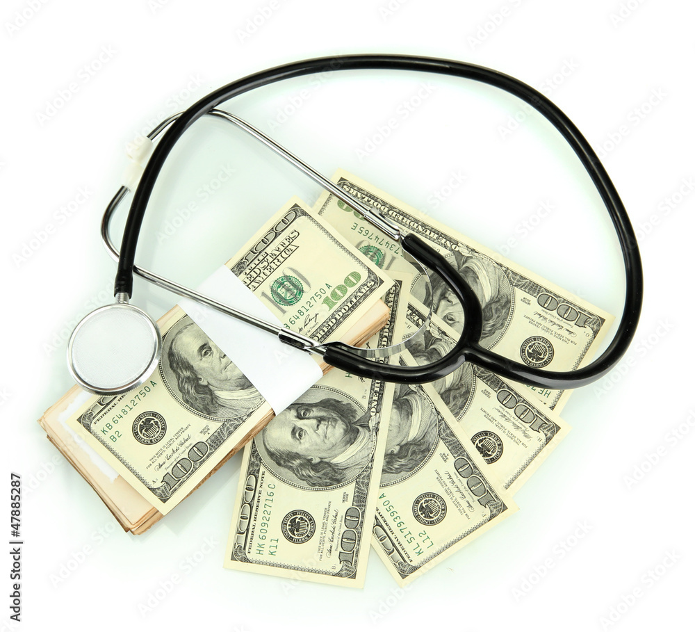 Healthcare cost concept: stethoscope and dollars isolated Healthcare cost concept: stethoscope and dollars isolated