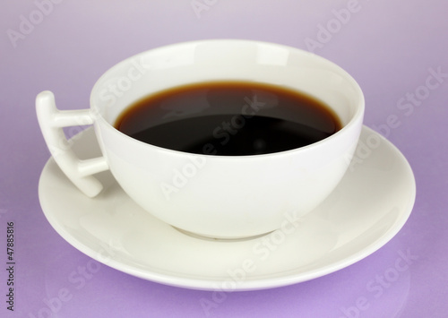 A cup of strong coffee on purple background