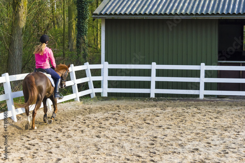 Fényképezés Young girl riding a running horse