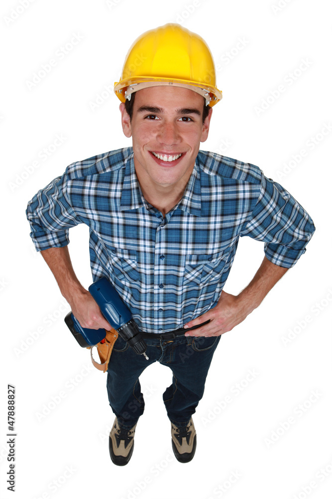 Young tradesman holding a power tool Young tradesman holding a power tool