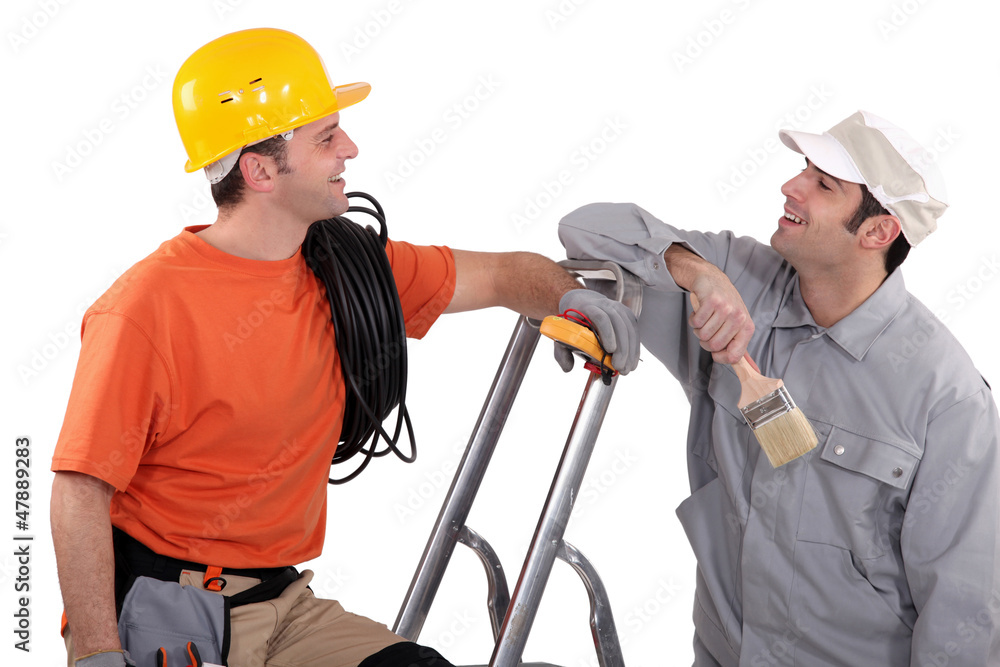 a house painter and an electrician laughing a house painter and an electrician laughing