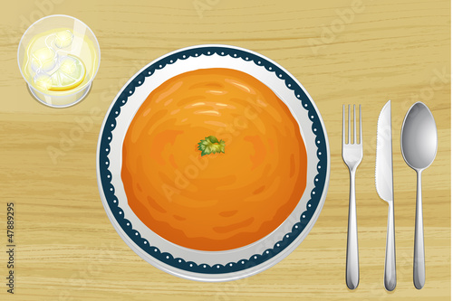 An orange soup on a plate