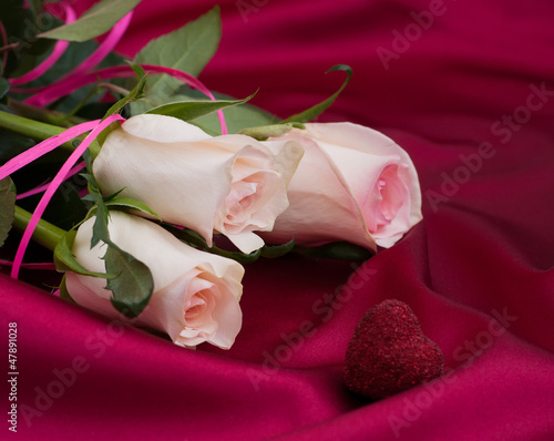 Roses on satin background photo