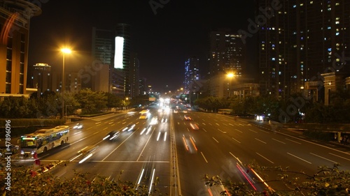 Cars quickly go on highway to Guangzhou Bridge in night photo