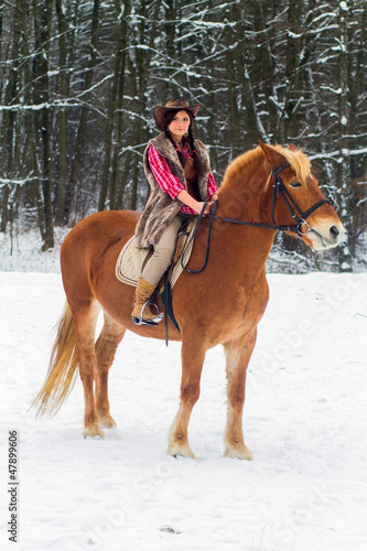 Woman Riding a Horse the Snow © asayenka