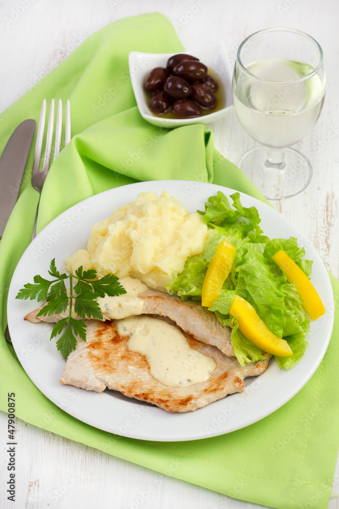 turkey with salad and potato on the plate