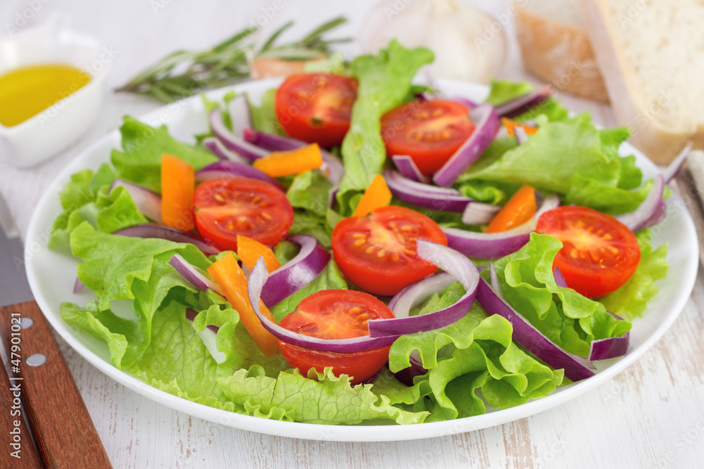 salad with onion on the plate and oil