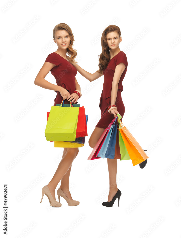 teenage girls in red dresses with shopping bags