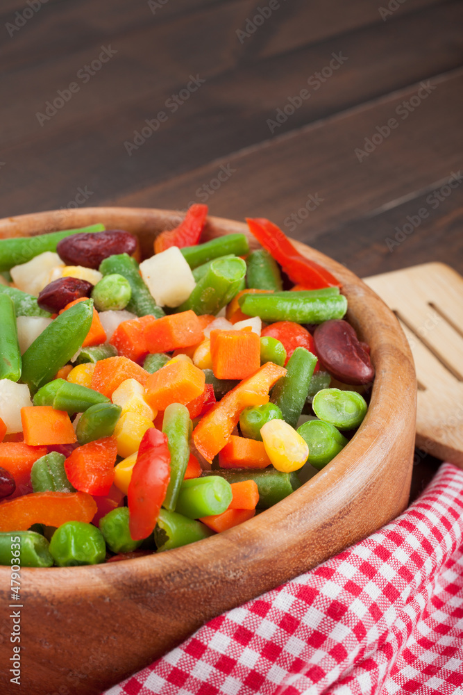 mixed vegetables in wooden bowl mixed vegetables in wooden bowl