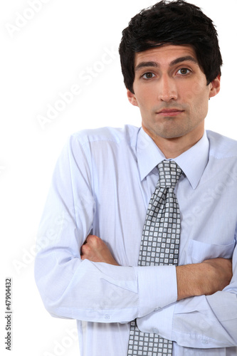 businessman standing with his arms crossed