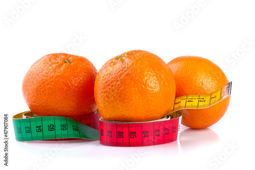tangerines and measure tape, isolated on white