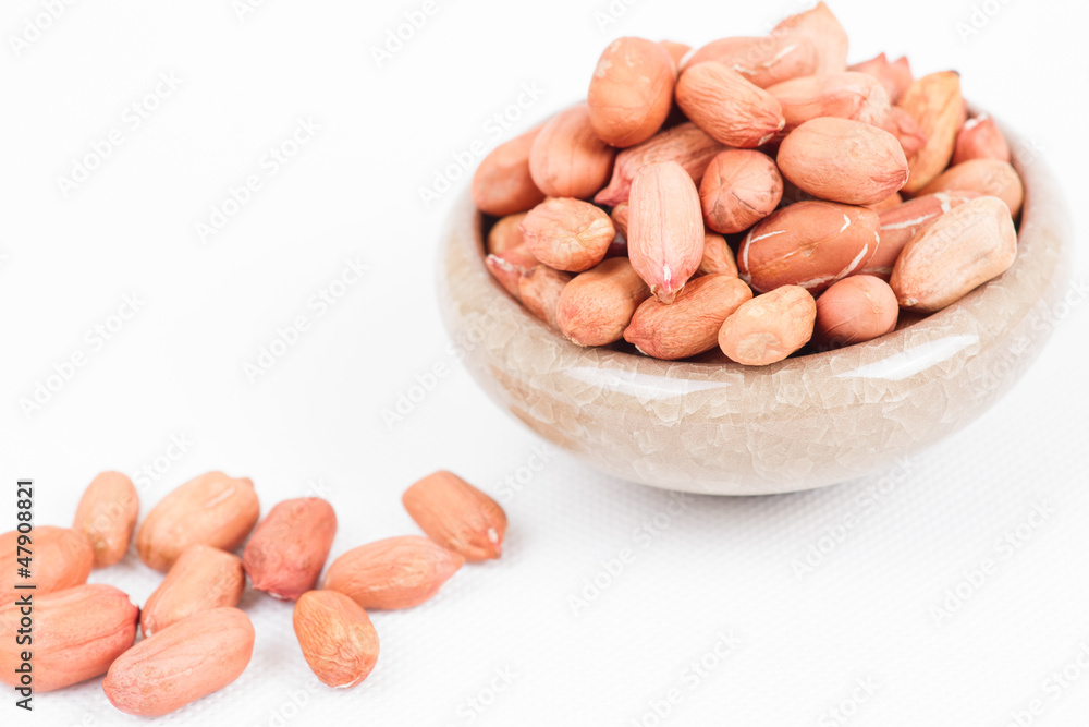 Peanuts in bowl on white Peanuts in bowl on white
