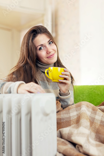   woman near oil heater photo