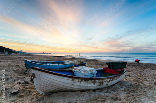Fototapeta Naklejka Na Ścianę i Meble -  Blue & White Boats on Beach at Sunrise