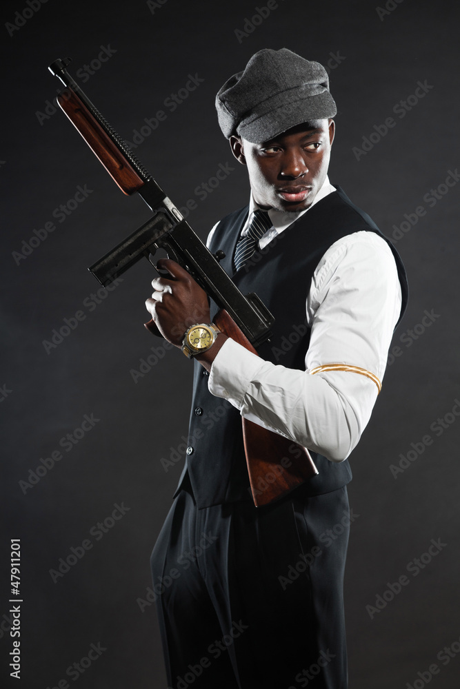 Black american mafia gangster man in suit with gun. Black american mafia gangster man in suit with gun.