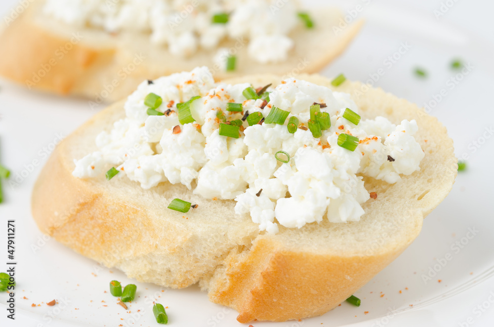 baguette with cottage cheese and green onion closeup