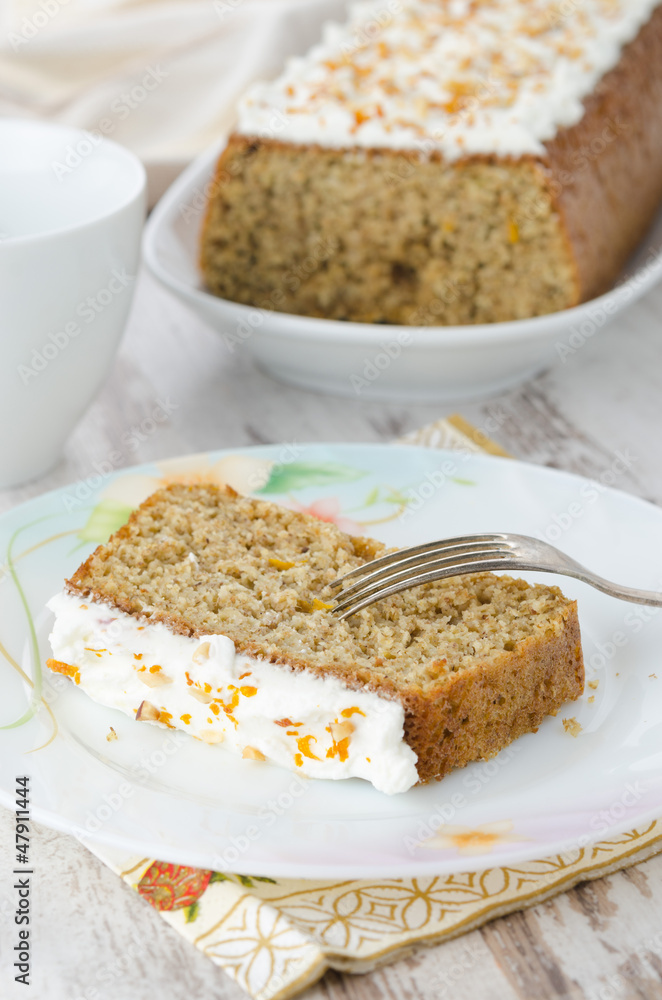piece of orange cake and cake in the background piece of orange cake and cake in the background
