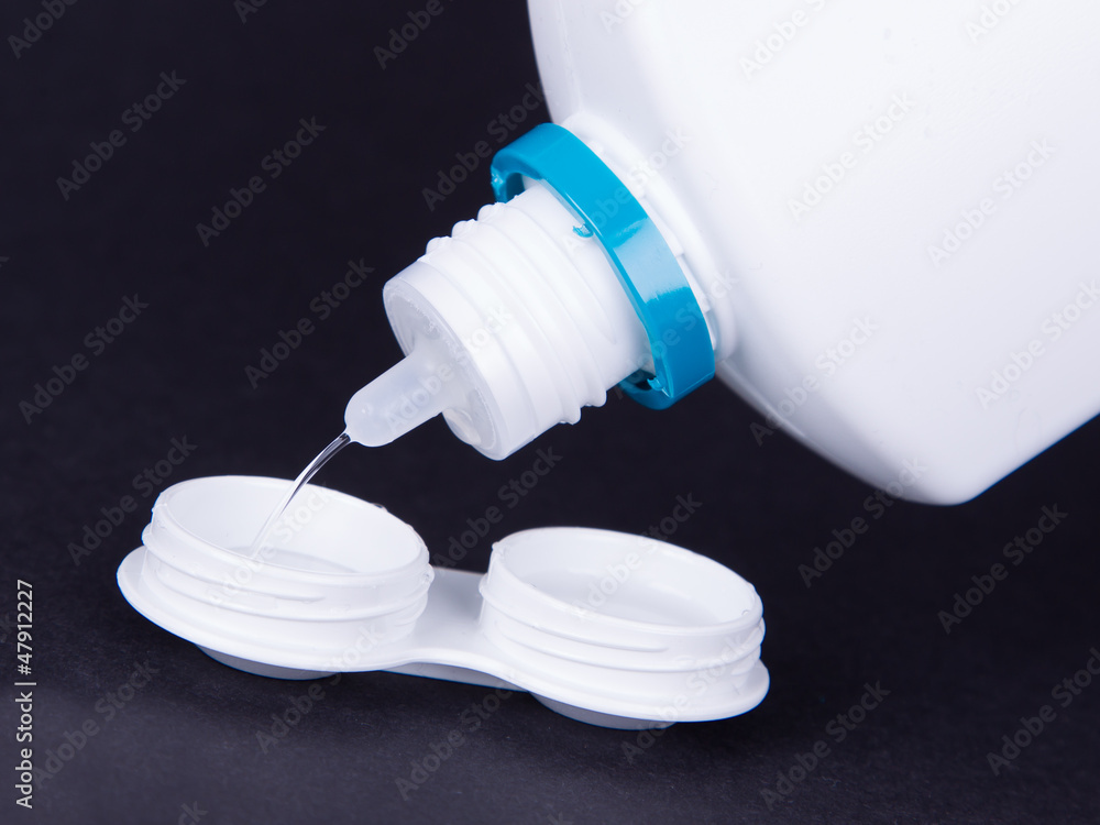 Lens casing and bottle of water isolated on black Lens casing and bottle of water isolated on black