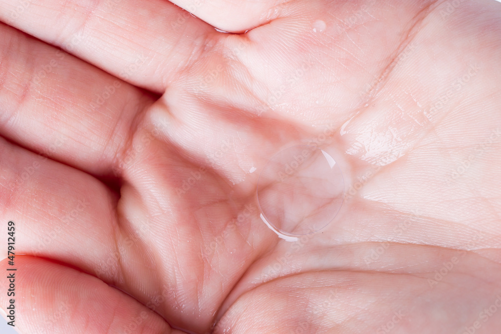 Woman holds a Contact Lens