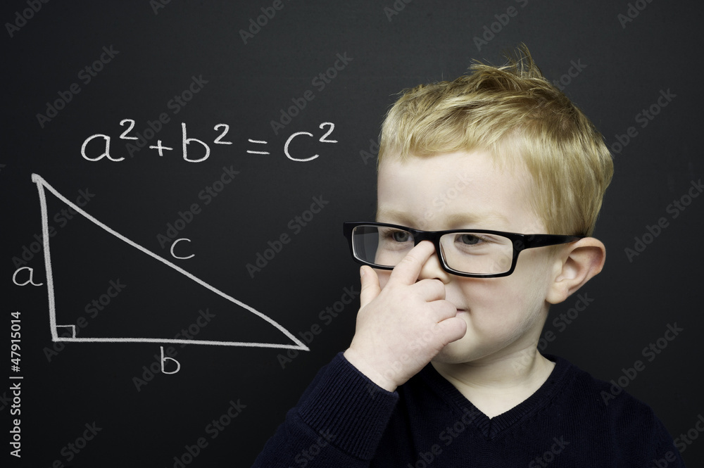 Smart young boy stood infront of a blackboard Smart young boy stood infront of a blackboard