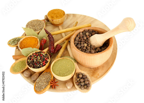 Fototapeta Naklejka Na Ścianę i Meble -  wooden mortar, bowls and spoons with spices isolated on white