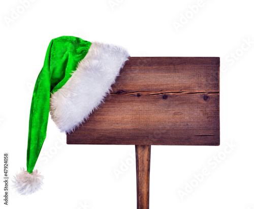wooden road sign with Santa hat 