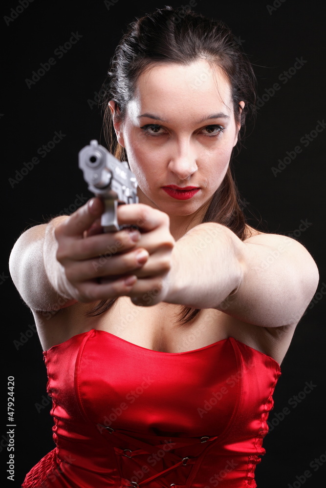 Sexy young woman - gun on black background Sexy young woman - gun on black background