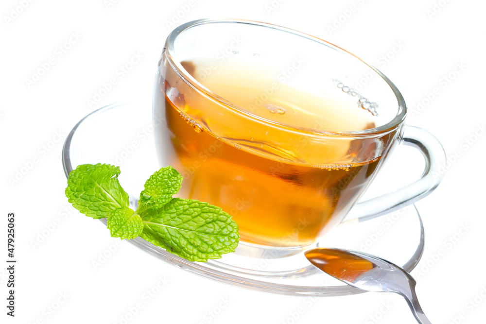 Tea cup with mint leaves on a white background Tea cup with mint leaves on a white background