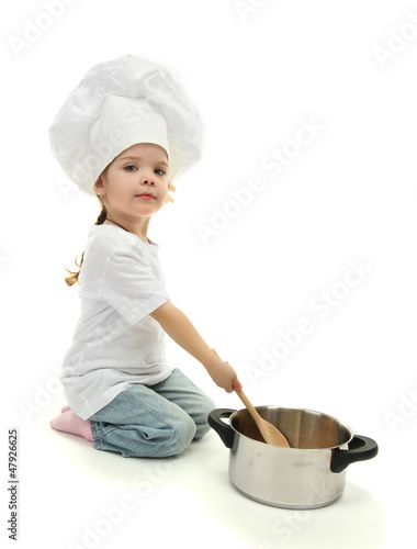 little girl doctor in chef's hat with pan and spoon, isolated