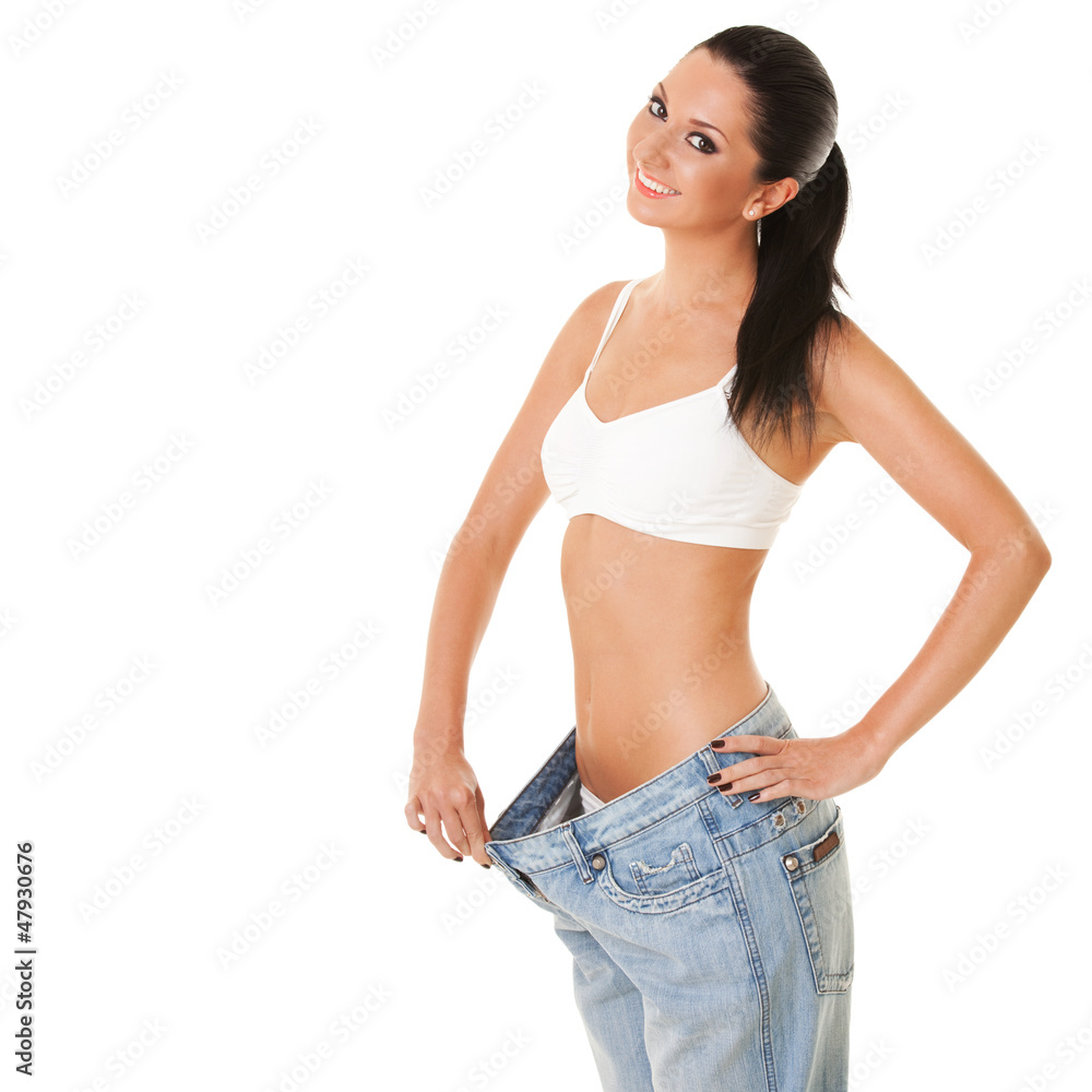Funny woman shows her weight loss by wearing an old jeans, isola Stock  Photo | Adobe Stock