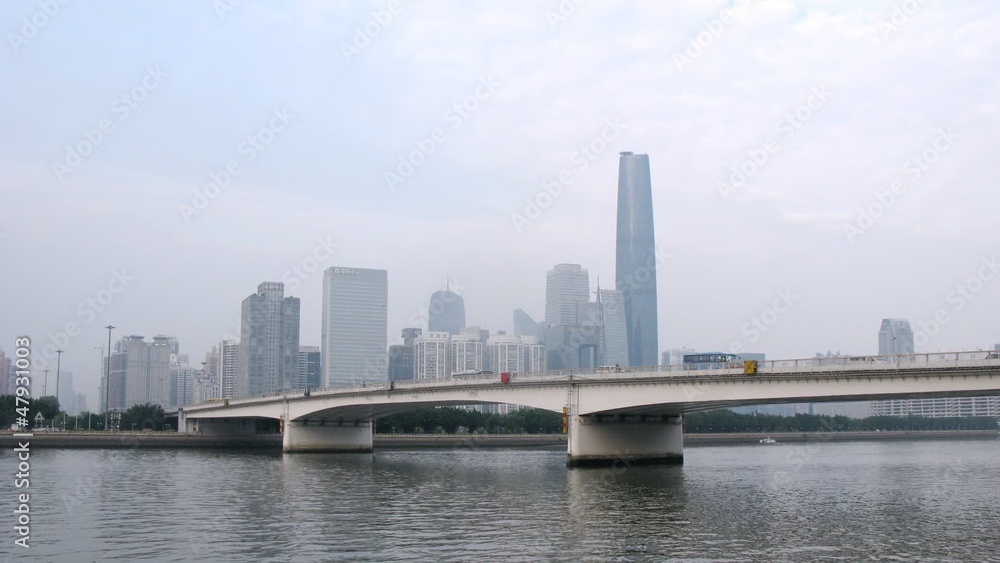 Cars go on bridge standing in front of Zhujiang New Town in Cars go on bridge standing in front of Zhujiang New Town in