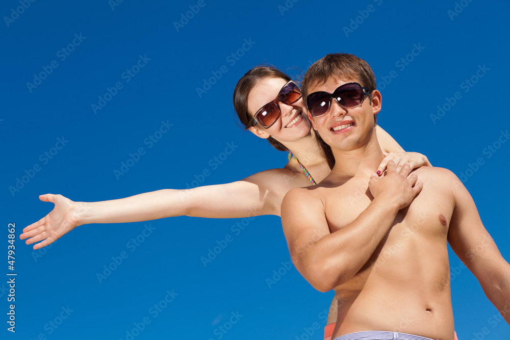 Happy Young Couple Together On The Beach