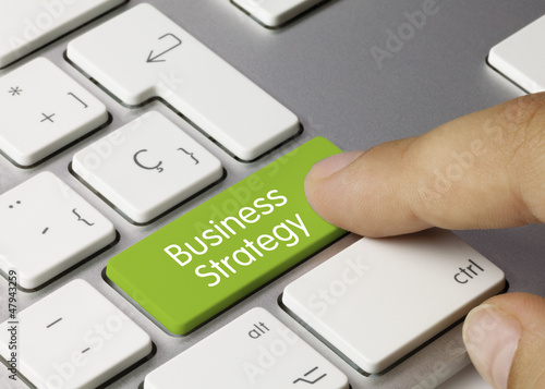 Business strategy keyboard key. Finger