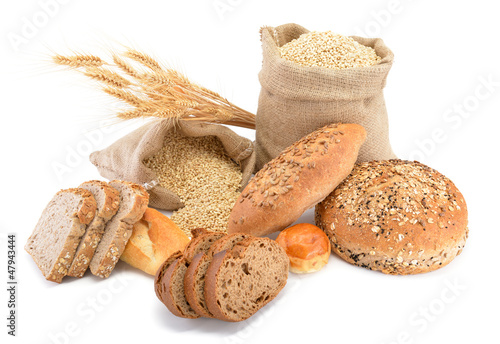 Assortment of baked bread over sack of wheat