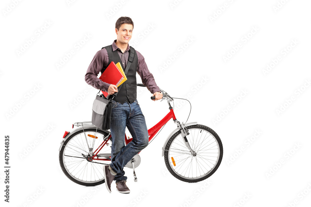 Smiling student holding books next to a bike Smiling student holding books next to a bike