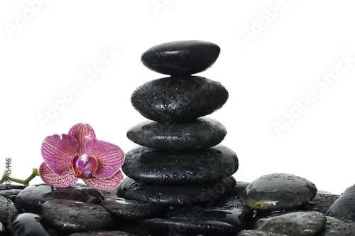 Therapy tower of stones with orchid flower with water drops