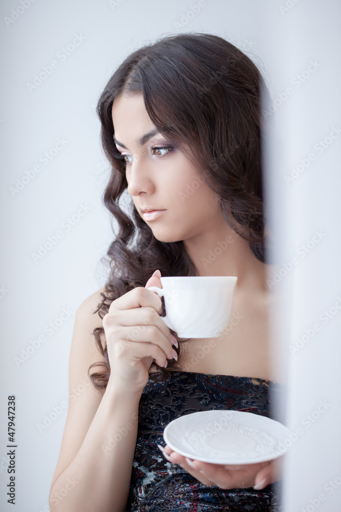 Pretty brunette woman drinking coffee Pretty brunette woman drinking coffee