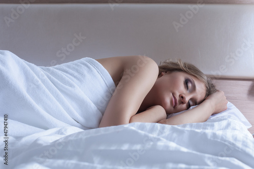 Pretty woman sleeping in bedroom