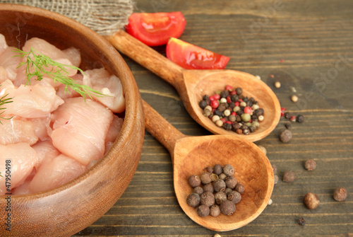 Fototapeta Naklejka Na Ścianę i Meble -  raw chicken meat in bowl, on wooden background