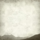 textured old paper background with outline of mountain range