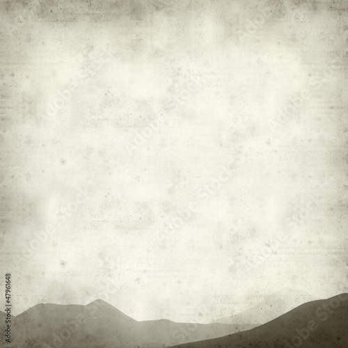 textured old paper background with outline of mountain range