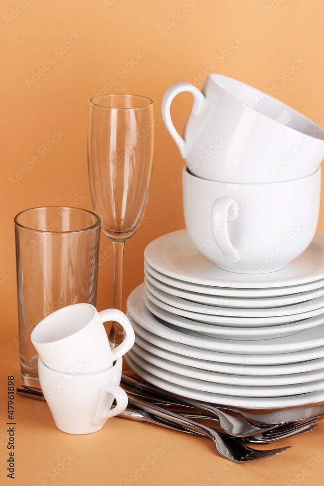 Fototapeta premium Clean white dishes on beige background