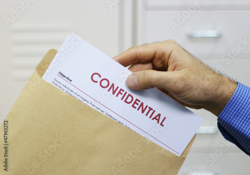 Man handling confidential documents photo