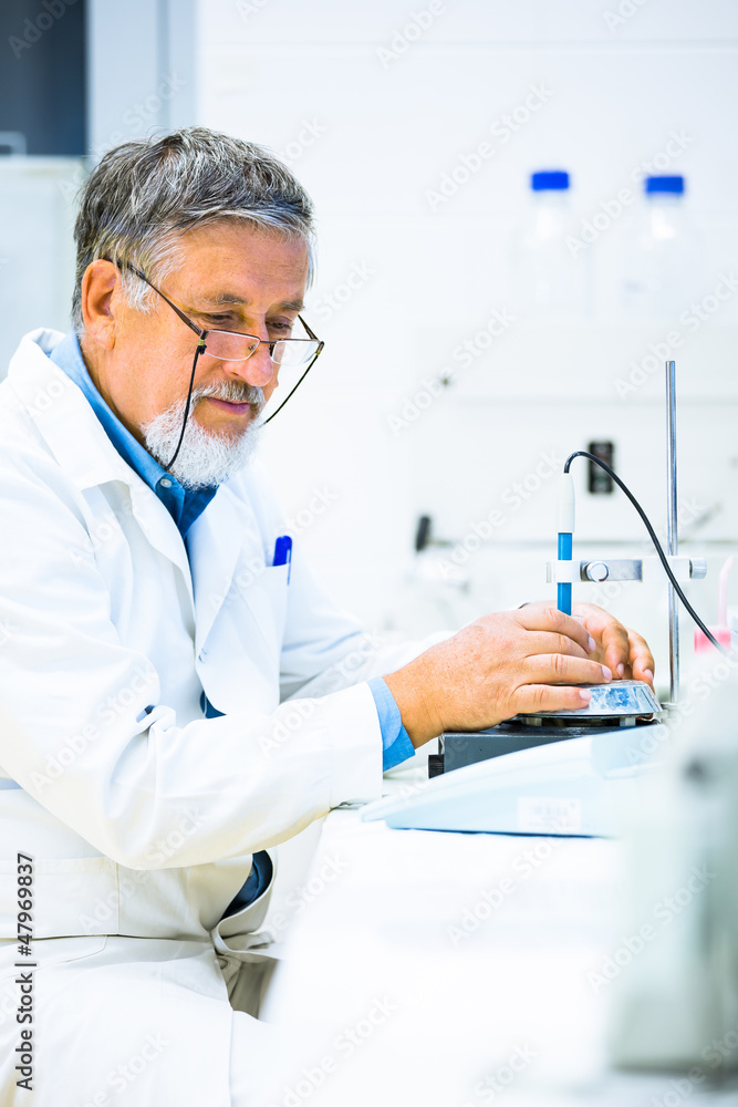 Senior male researcher carrying out scientific research in a lab Senior male researcher carrying out scientific research in a lab